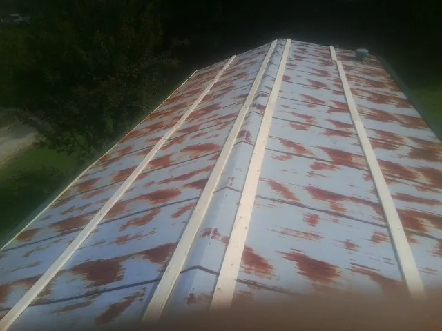Rusted metal roof panels with new wood purlins before replacement — Storm Damage Roof Repair in Westbrookville by Roofing Brothers