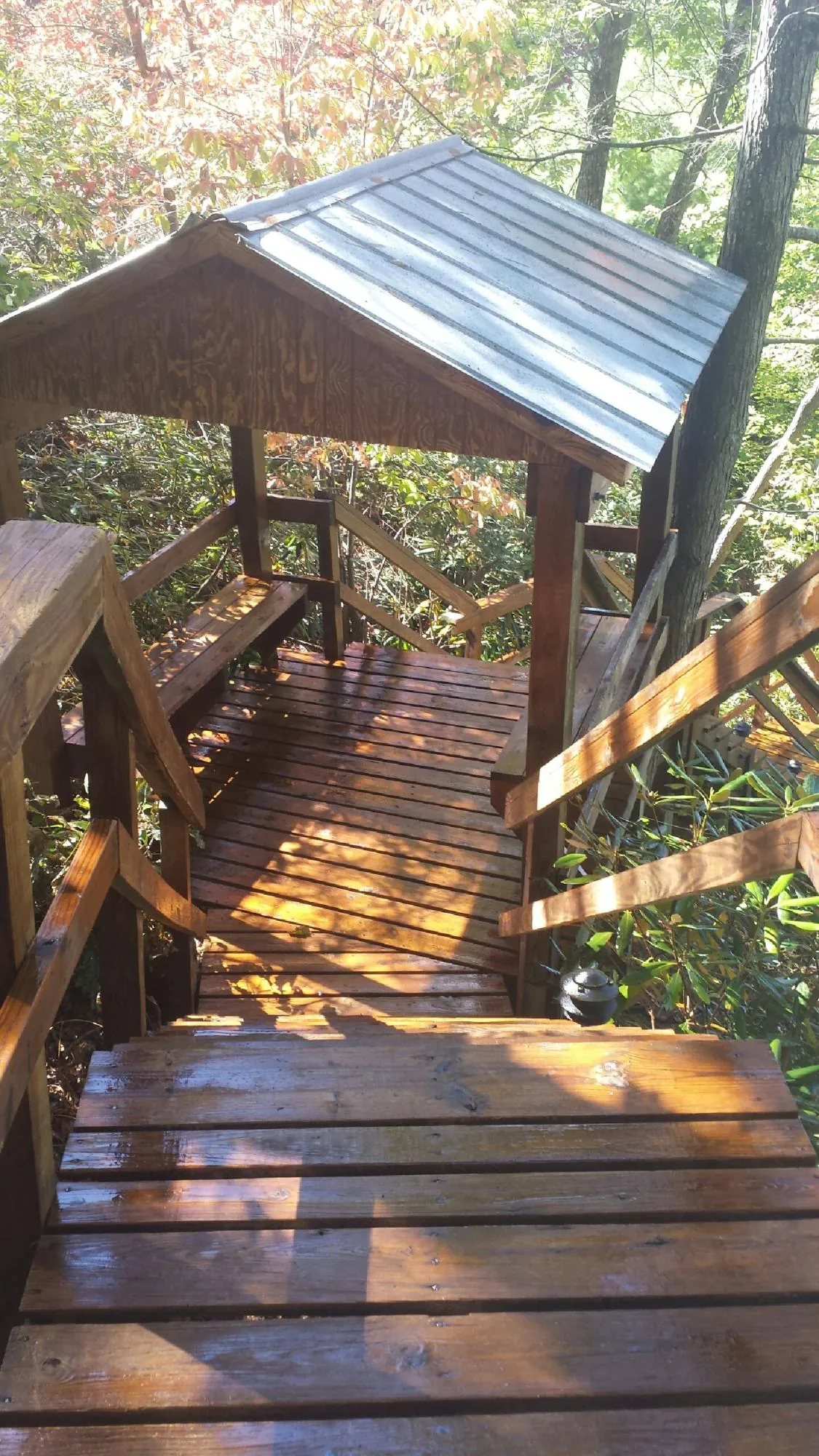 Freshly stained wood walkway and covered shelter with a metal roof in Westbrookville