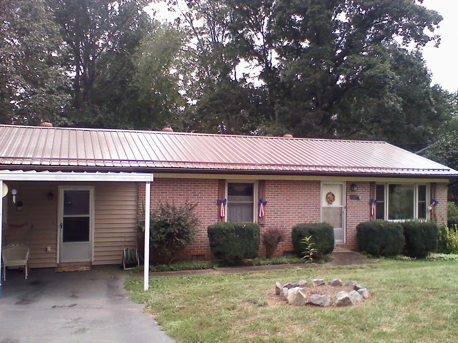 Bronze metal roof and carport on a brick ranch home — Roof Repair work by our crew in Westbrookville